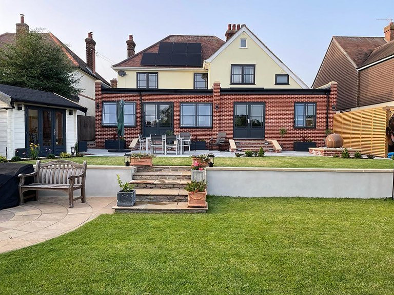 Rear extension with glazing opening onto a garden and patio.